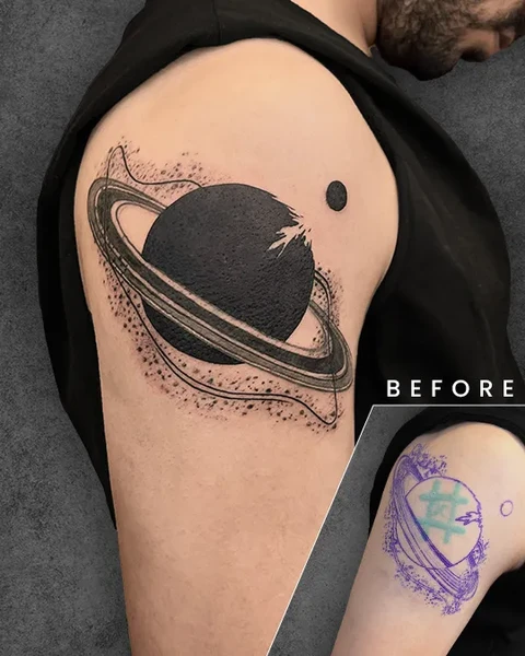 A vibrant black tattoo featuring Saturn, covering up a smaller tattoo that previously existed on the arm. The original tattoo is faint and unclear but visible in the bottom-left inset.