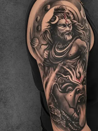 Dynamic Double exposure Shiva tattoo on the upper arm of a male, with bold elements including a fierce demon face.
