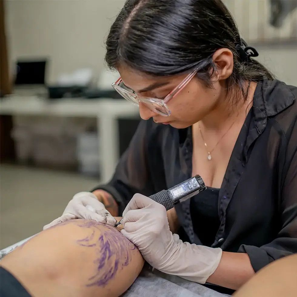 Sakshi Panwar inking Tattoo on Arjun Kapoor's calf