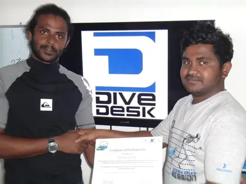 Managing Director Adam Ashraf of Dive Desk receiving the official Green Fins membership certificate, recognizing the dive centres’ commitment to sustainable diving in the Maldives.