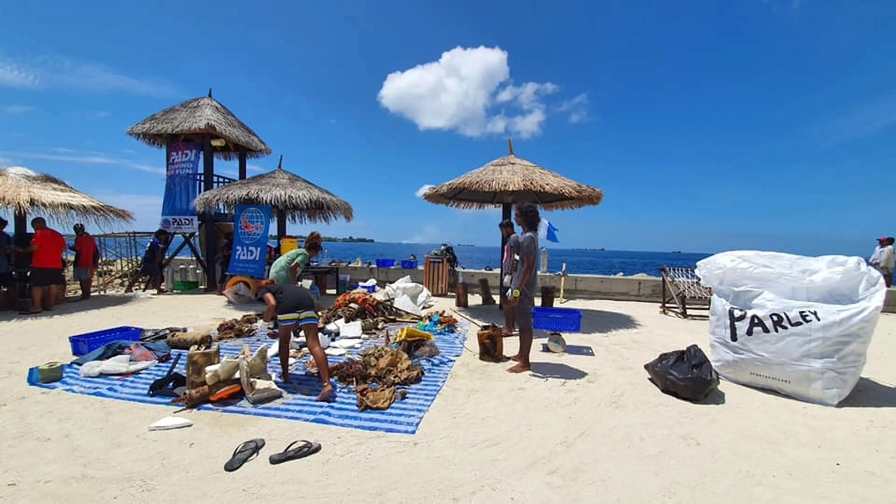 PADI Dive Against Debris course participants collecting and segregating marine debris taken from underwater with Dive Desk Male' and the Maldivian Academy of Diving Himmafushi in the Maldives.