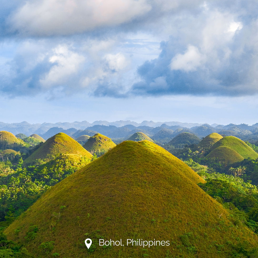 Chocolate Hills in Bohol with symmetrical grass‑covered hills under a partly cloudy sky