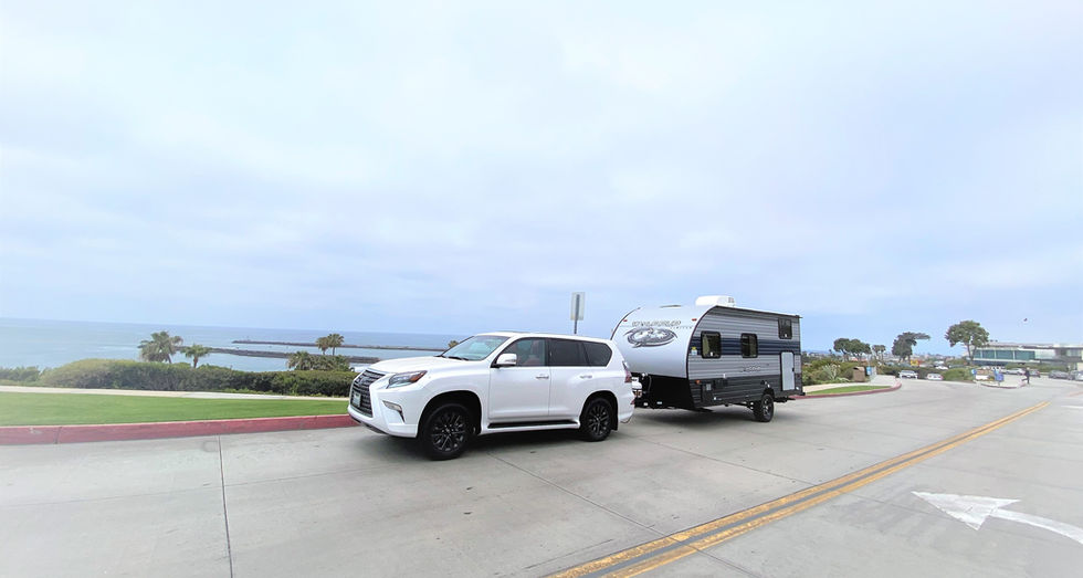 Ultralight Tart trailer hitched and driving towards a campsite, perfect for weekend getaways