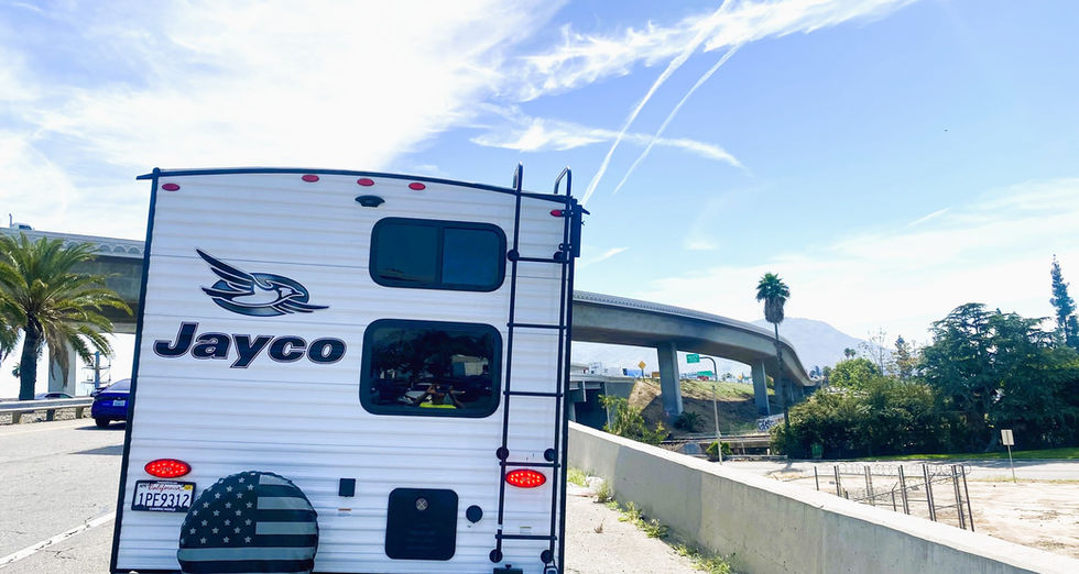 Jam Caravan Jayco Jay Flight RV Rentals cruising toward Joshua Tree National Park getaway.
