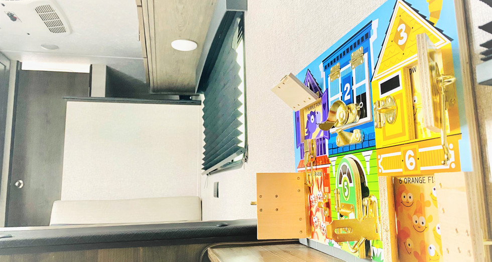 Installed busy board for kids inside the Family Cupcake travel trailer, making it child-friendly and engaging