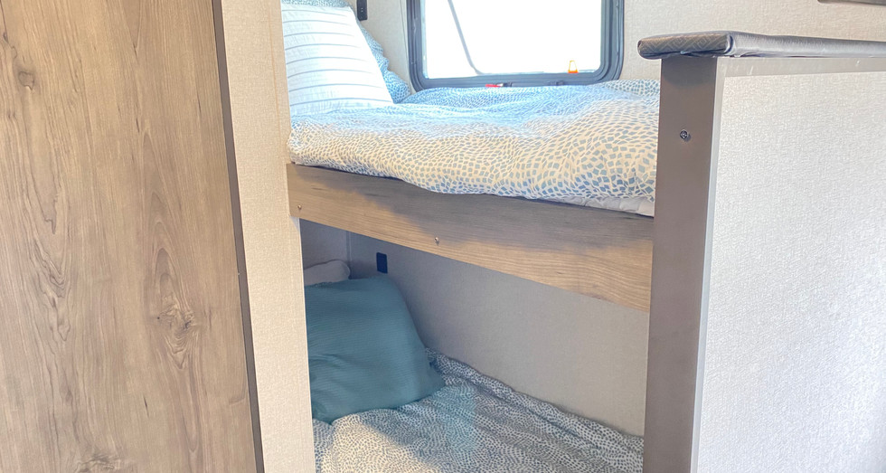 Bunk beds inside the Family Cupcake travel trailer, offering extra sleeping space for kids or guests