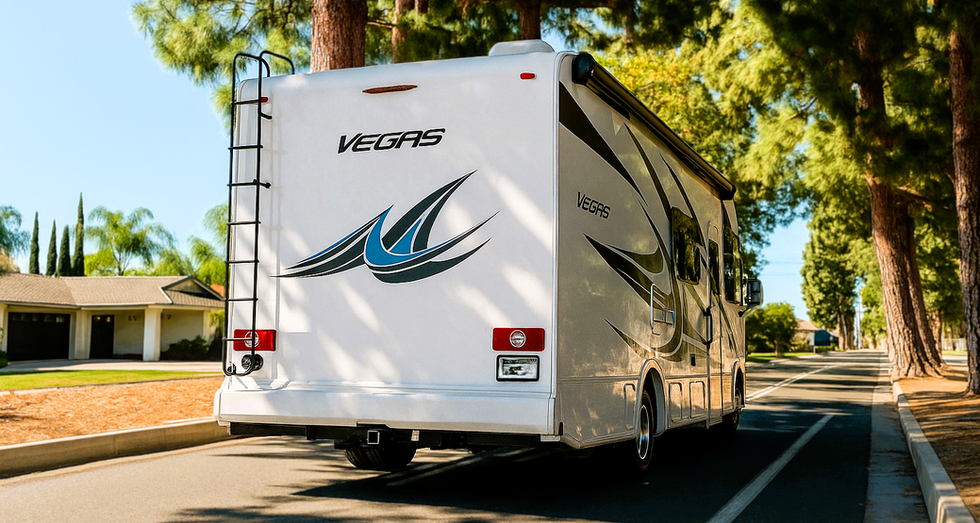Back view of Vegas motorhome parked under pine trees in Orange County.