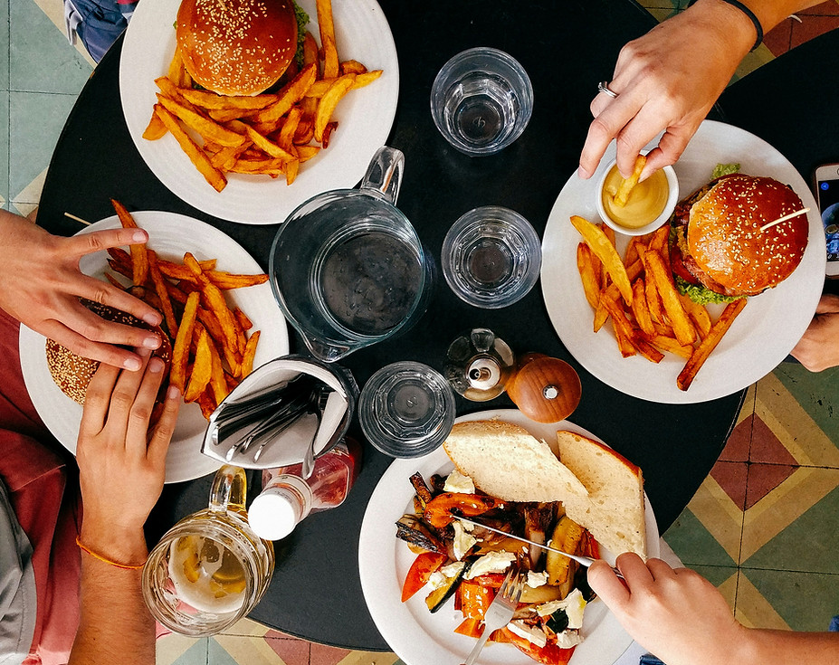 Overhead image of people eating assortment of food at restaurant