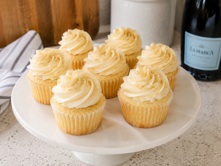 Homemade Champagne Cupcakes with champagne buttercream frosting arranged on a white serving platter.