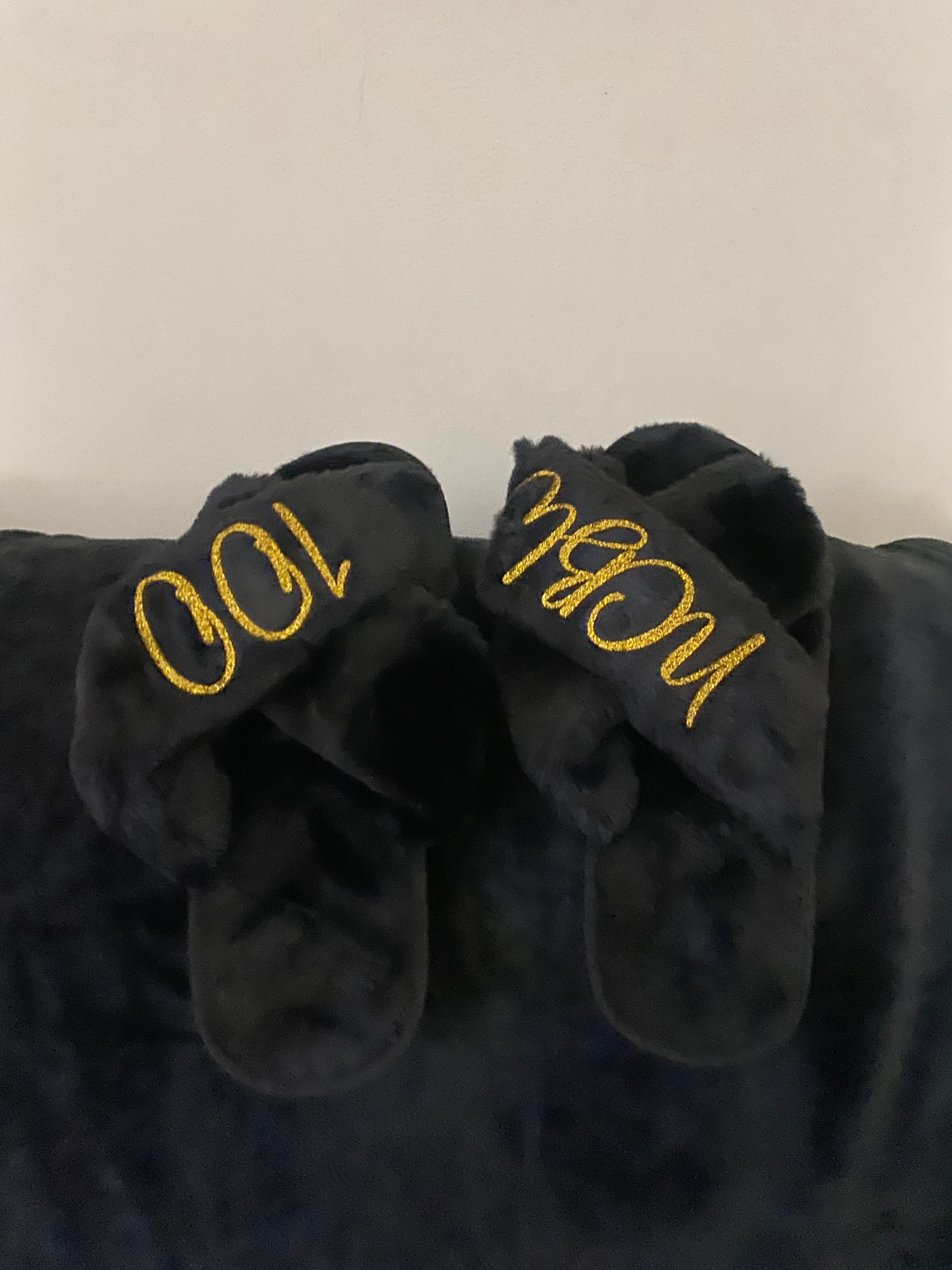 Black Slippers with NCBW100 embroidered on them