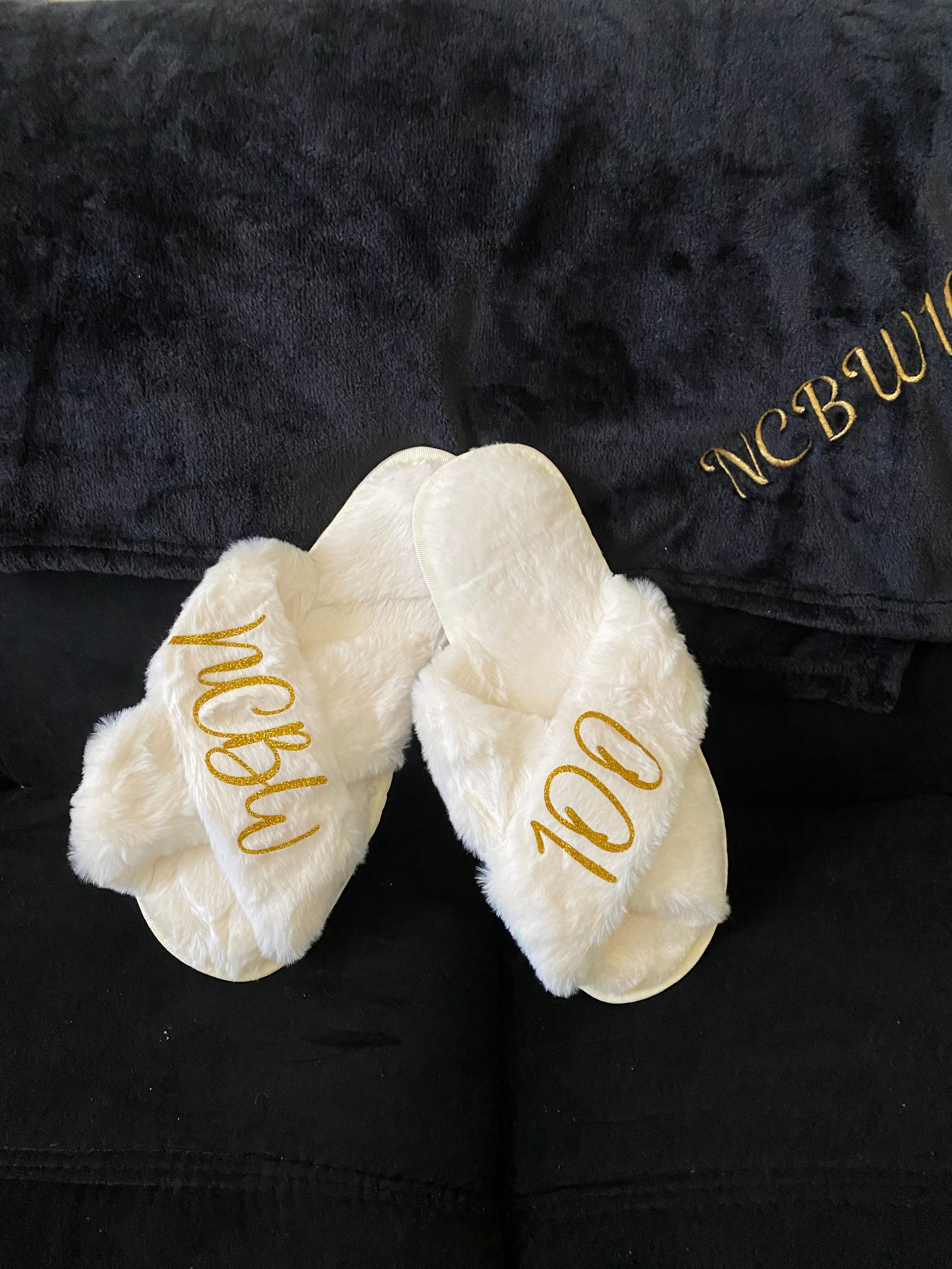 Cream Criss Cross Slippers with NCBW100 embroidered on them