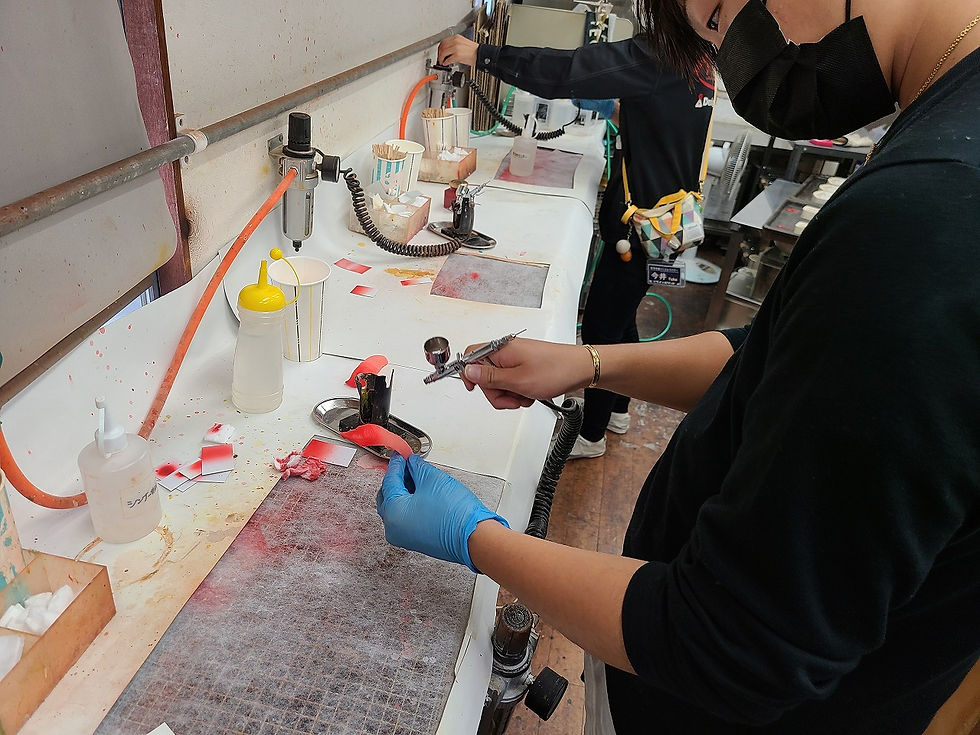 close-up view of hands shaping a realistic food sample in a workshop