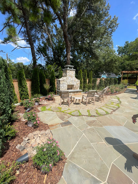 outdoor fireplace built beside a custom pool in atlanta, ga