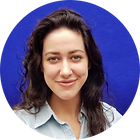 Katie Kaufman Gibbons | A woman with long dark hair against a blue background.