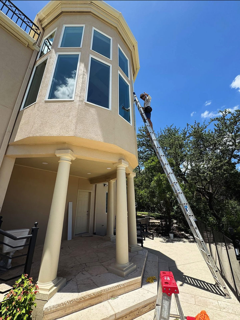 Proffesional window cleaner using a large ladder to reach very high up windows