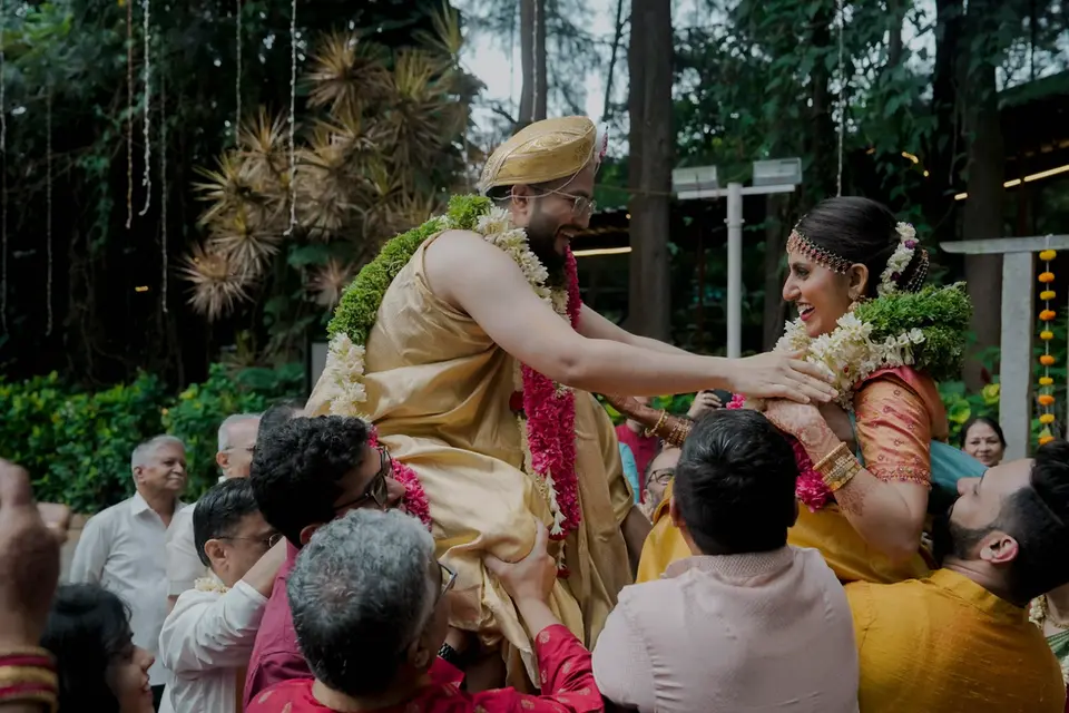 An image of bride and groom during a fun south indian wedding ritual
