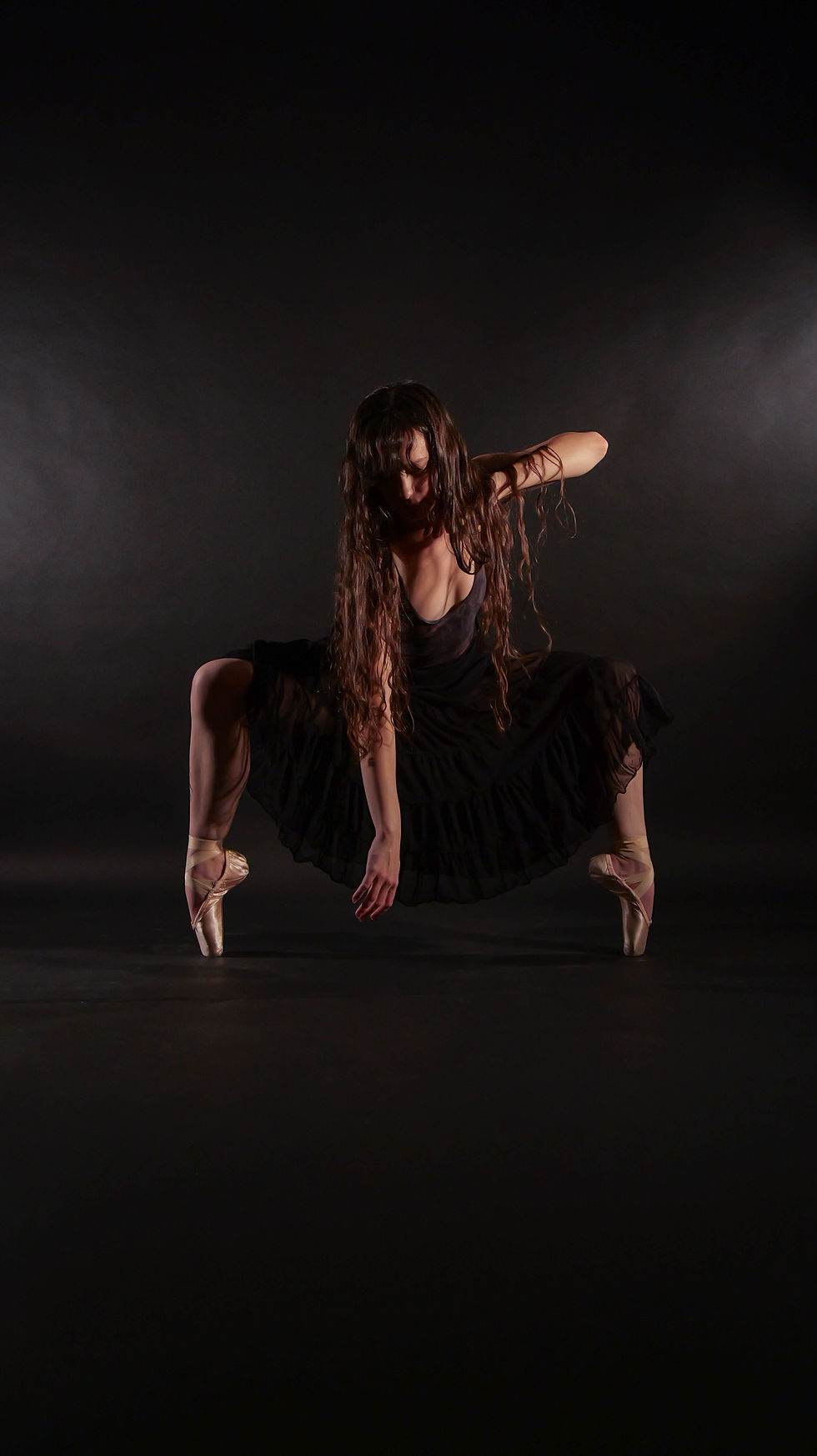 adult dancer with hair down wearing pointe shoes