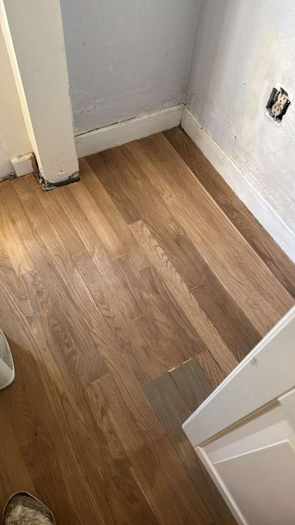 Wooden floor with light and dark planks.