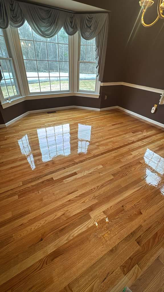 Completed MSI Kings Buff Oak hardwood floor installation in a Framingham, MA living room.