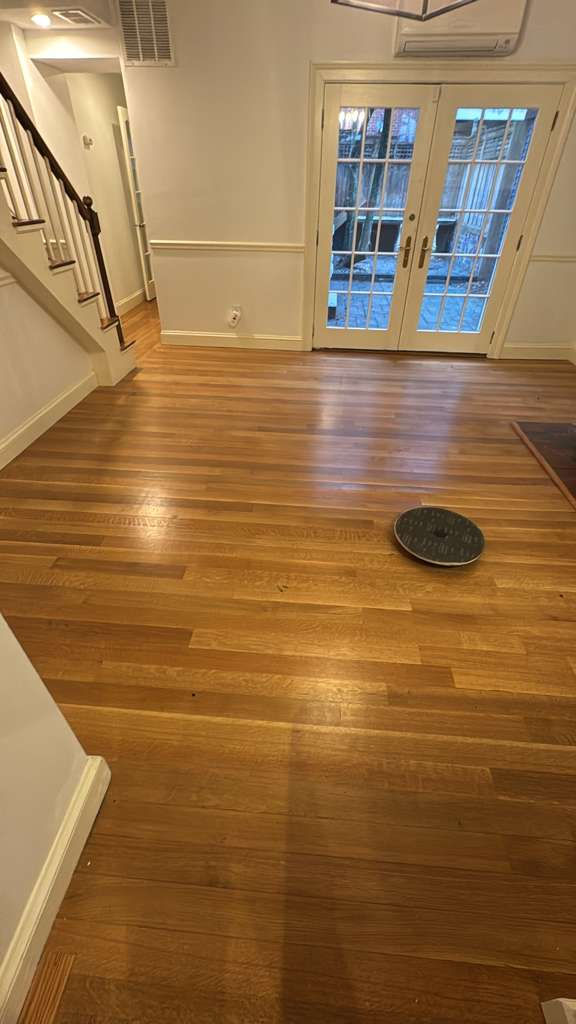 Wooden floor with a robotic vacuum cleaner.
