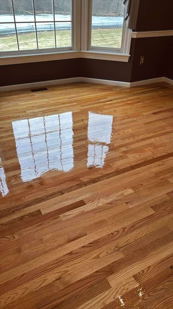 Completed MSI Kings Buff Oak hardwood floor installation in a Framingham, MA living room.