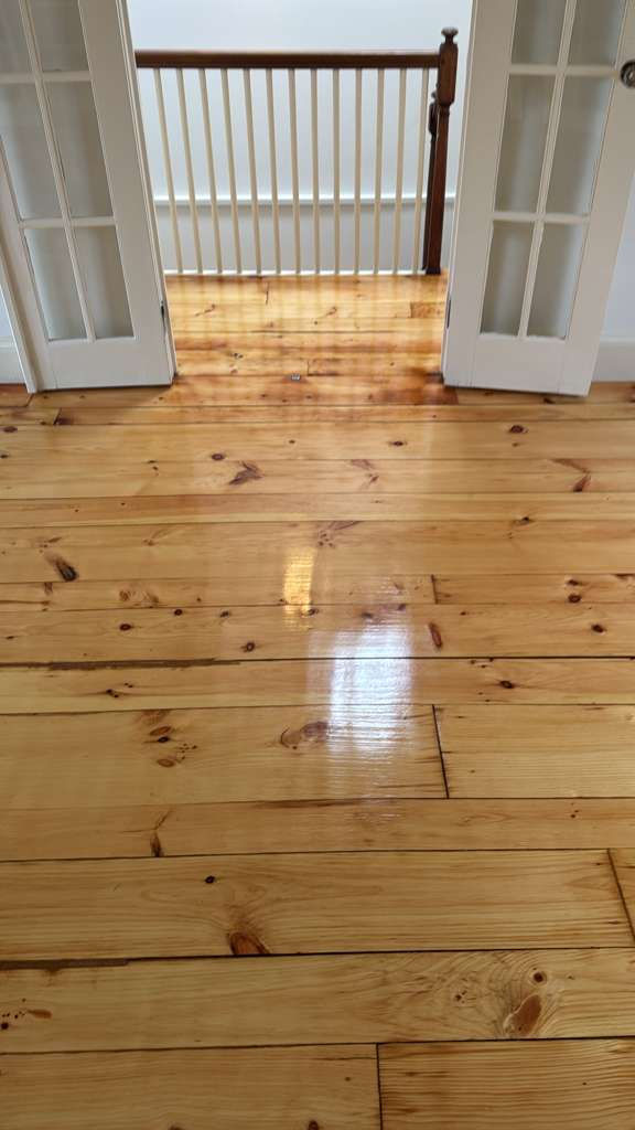Refinished pine wood floors in Downtown Boston with 3 coats of Absco finish.
