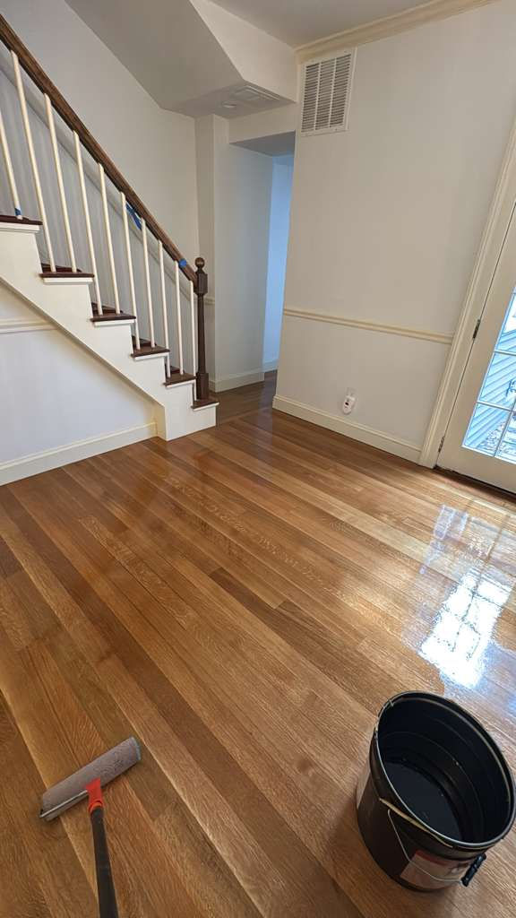 Shiny wooden floor in a bright, empty room.