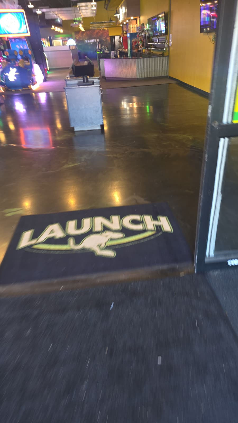 Entrance mat with "LAUNCH" and kangaroo logo.