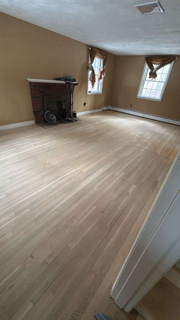 Smooth, restored hardwood floor after professional refinishing service in a Billerica MA home.