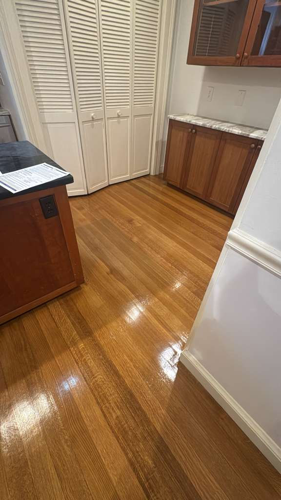 Shiny wooden floor in a kitchen setting.