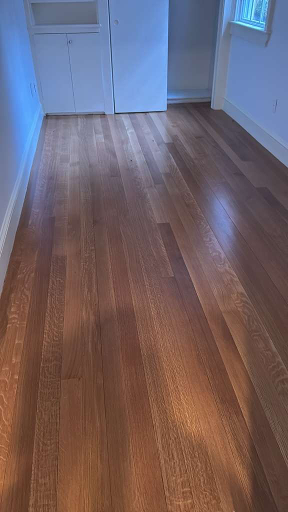 Wooden floor in a narrow hallway.