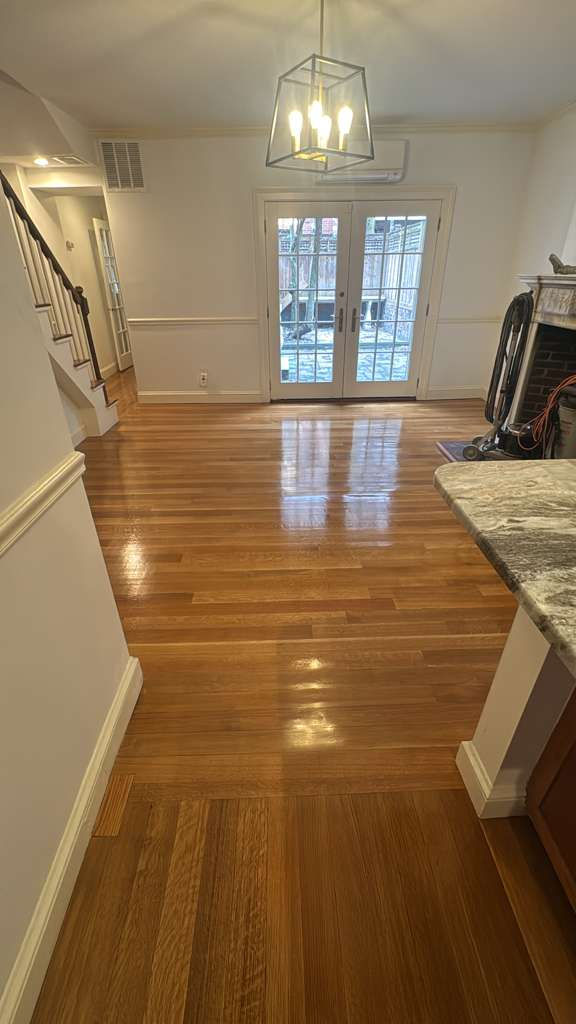 Shiny wooden floor in a bright, empty room.