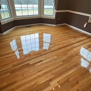 Completed MSI Kings Buff Oak hardwood floor installation in a Framingham, MA living room.