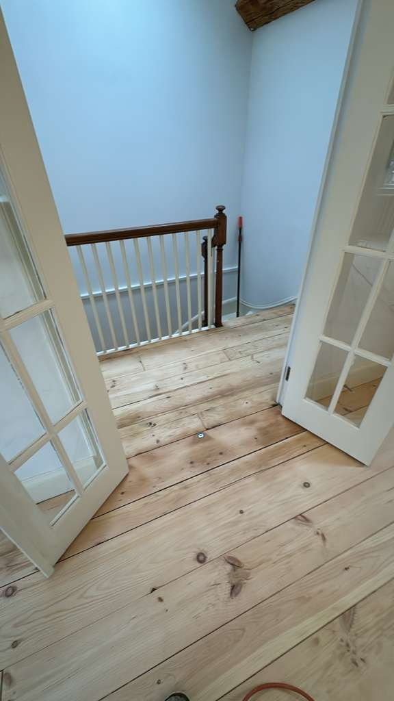 Refinished pine wood floors in Downtown Boston with 3 coats of Absco finish.