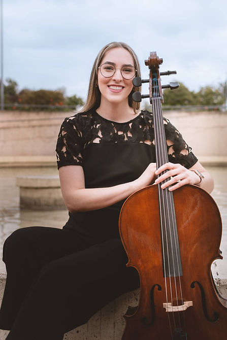 Teacher MarÃa Laura with cello, Kingwood Arts Academy, Houston TX.