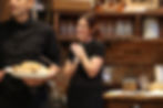 Woman smiling with hands clasped at wedding