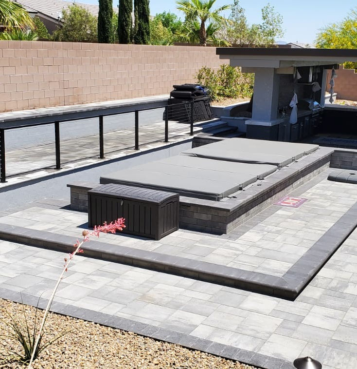 Modern backyard patio with built-in spa and grill