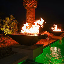 Fire and water feature fountains by a lighted pool Lake Las Vegas