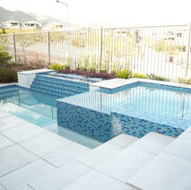 Stunning modern pool design featuring blue tile accents