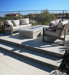 Modern outdoor fire pit with surrounding seating area.