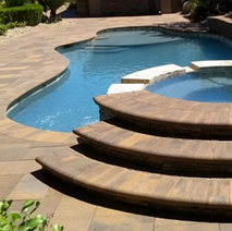 Luxury pool design featuring a tanning ledge and spa