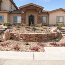 Landscaped home with stone retaining walls.