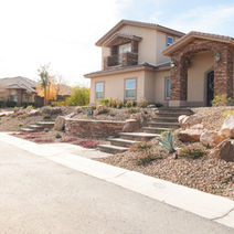 Desert-style landscaped home with stone steps.
