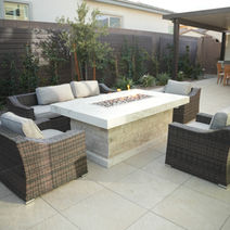 Modern gas fire pit surrounded by seating.