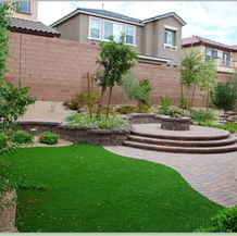 Las Vegas backyard with artificial turf, modern patio, and fire pit