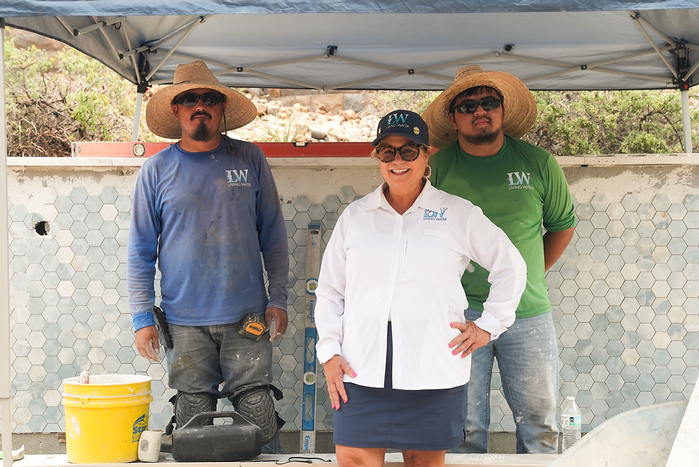 The Living Water team proudly stands by their custom water feature installation, showcasing their expertise in design and construction.