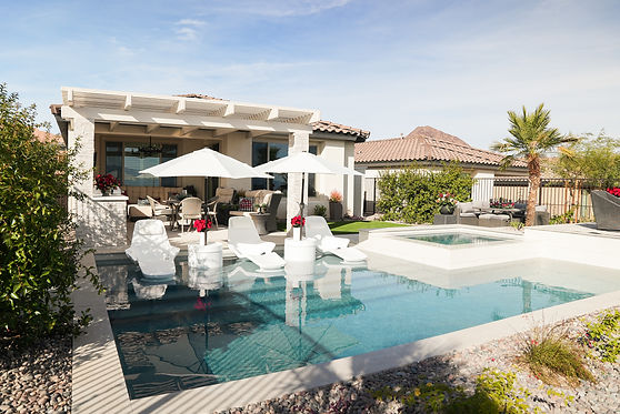 Luxury pool and spa area featuring stylish patio furniture