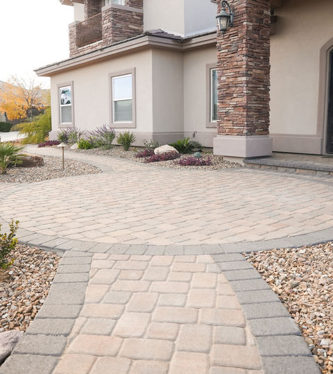 Elegant Las Vegas home entry featuring courtyard paving and desert landscaping