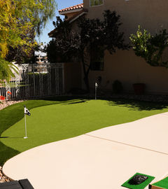 Putting green with flags and lush artificial turf. Backyard landscaping with LivingWaterLV.