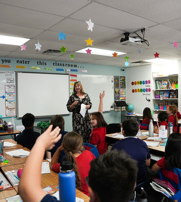 Christine McLoone presenting chicken anatomy to 3rd grade students of International Christian Academy.